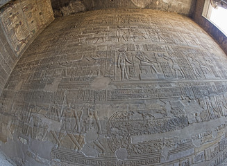 Hieroglyphic carvings on an ancient egyptian temple wall
