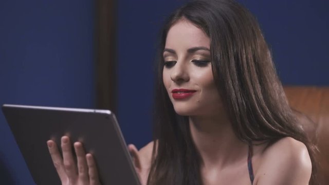 Smiling young beautiful woman using tablet