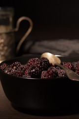 Frozen blackberries on a black plate