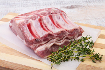Raw pork chops, spices and rosemary on cutting board. Ready for cooking.