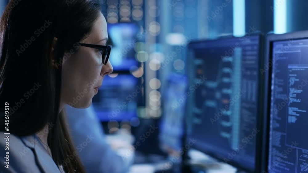 Aufkleber close-up footage of female it engineer working in monitoring room. she works with multiple displays.