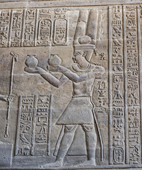 Hieroglyphic carvings on an ancient egyptian temple wall