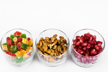 Small glass with dried fruits, nuts, pomegranate