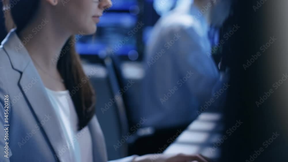Aufkleber close-up footage of female it engineer working in monitoring room. she works with multiple displays.