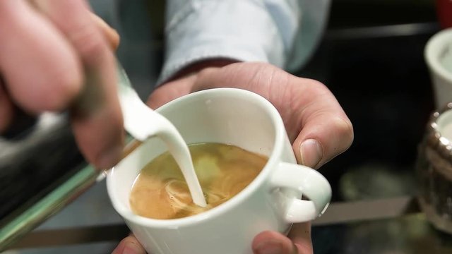 cup with hot cappuccino in man hands