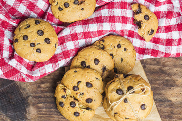 freshly baked chocolate chip cookies on rustic wooden table