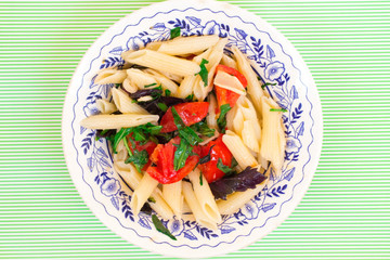 Cold appetizer of pasta, tomato and basil
