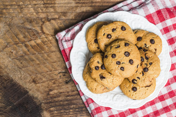 freshly baked chocolate chip cookies on rustic wooden table
