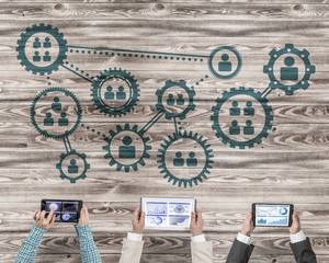 Top view of businesspeople sitting at table and using gadgets