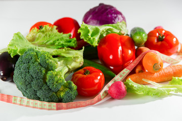 Vegetables and measuring tape, still life isolated on white background