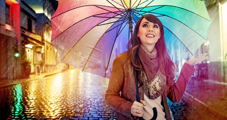 Fashionable brunette with a colorful umbrella