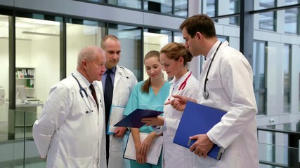 Team of doctors discussing over medical report