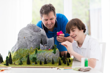 Father and son work on model building project