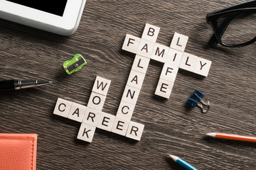 Conceptual keywords on wooden table with elements of game making crossword