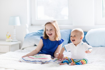 Kids playing on parents bed