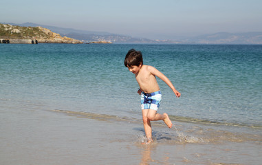 Fototapeta na wymiar happy child running in the beach