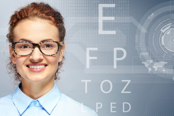 Young woman with spectacles on grey background