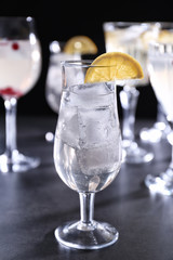Refreshing cocktail with lemon slice on table