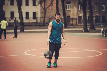 African-american streetball player practicing outdoors
