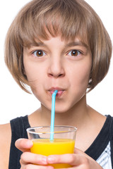 Beautiful caucasian little girl drinking fresh orange juice. Emotional portrait of attractive happy child with glass, isolated on white background.