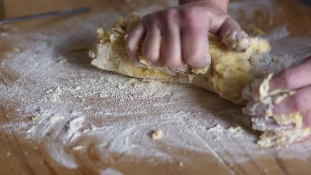  kneading fresh dough:Hands of woman kneads dough