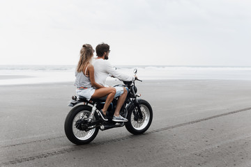Fototapeta na wymiar Young beautiful couple riding motorcycle