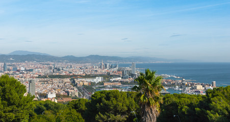 Beautiful Blue commerce.  Coastline of Spain in seaside Barcelona.  Modern city scape & coastline as seen from high level, cable car over the city. 