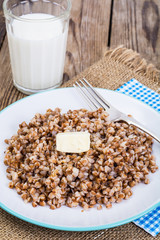 Glass with milk and boiled buckwheat porridge