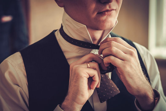 Man tying custom made bowtie
