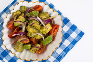 Healthy and dietary food: salad with avocado and tomatoes
