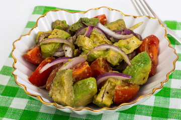 Healthy and dietary food: salad with avocado and tomatoes