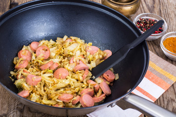 Sour cabbage stewed with slices of sausages