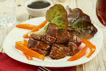 Goulash. Beef stew with fresh salad, sweet pepper and red dry wine. Close-up, selective focus, toned in Photoshop.