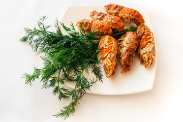 Spiked shrimp-bear with dill on white plate, dill