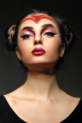Pofrtrait fashion young model.Futuristic makeup art. Top knot hairdo.Perfect beaty skin