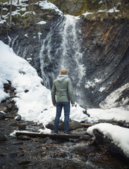 Traveler on the waterfall background. Concept and idea
