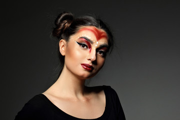 Pofrtrait fashion young model.Futuristic makeup art. Top knot hairdo.Perfect beaty skin