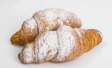Fresh warm croissants on white background