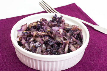 Braised red cabbage in white salad bowl