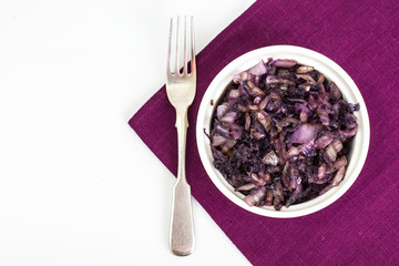 Braised red cabbage in white salad bowl