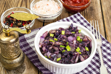 Braised red cabbage in white salad bowl