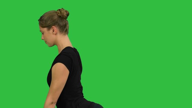 Side view portrait of beautiful young woman doing yoga or pilates exercise. One Legged King Pigeon pose, Eka Pada Rajakapotasana on a Green Screen, Chroma Key