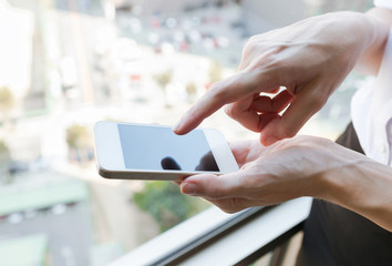 Closeup of hand using smartphone. 