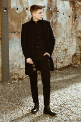 Young handsome man in elegant black clothes