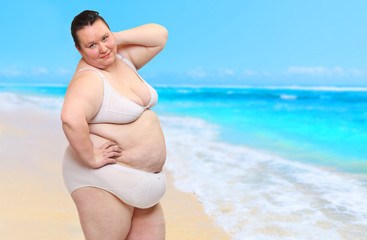 Obese woman enjoy life on tropical beach. Healthy lifestyle and slimming theme. Happy sumer holidays for all.
