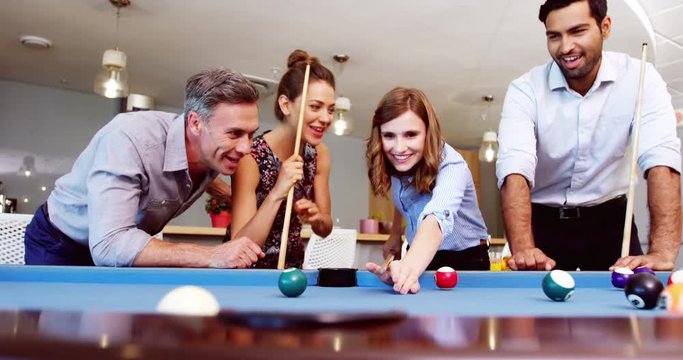 Executives playing pool in office