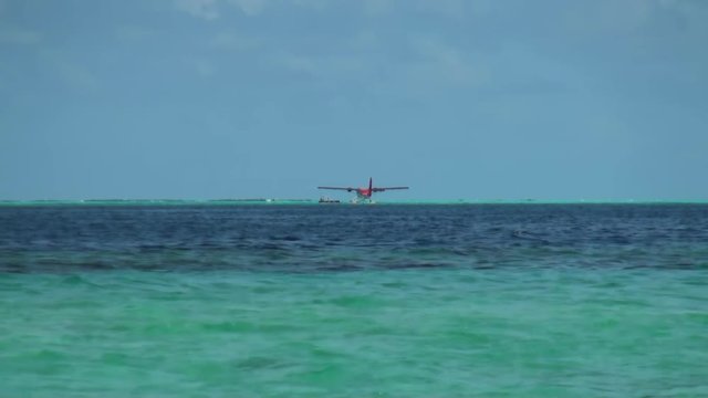 Seaplane on background water surface and horizon in Maldives. Pleasant journey into the world of beautiful nice nature. A unique landscape.