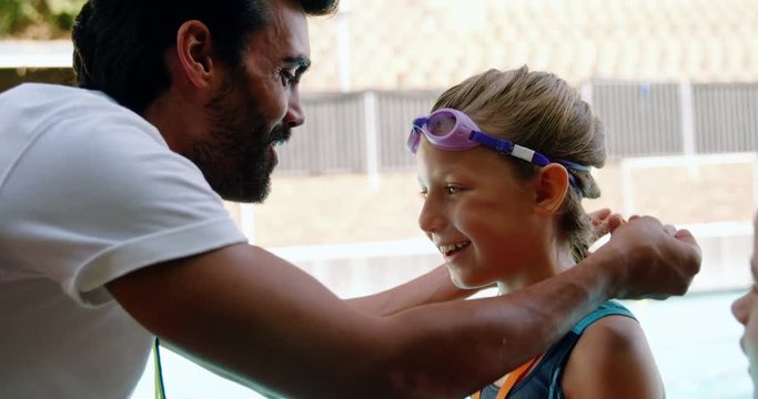 Male trainer giving gold medal to his student