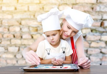 Woman and child cooking.