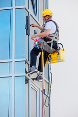 window washer working  at building outdoor